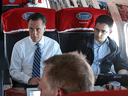 Former Massachusetts Gov. Mitt Romney and Oren Cass aboard his presidential campaign plane in 2012. Cass questions the mantra a growing economy benefits everyone and dismisses the idea a free market is always right.