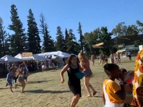 People run as an active shooter was reported at the Gilroy Garlic Festival, south of San Jose, California, U.S., July 28, 2019 in this still image taken from a social media video.
