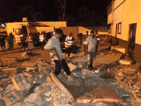 Security and emergency personnel at the site of an airstrike at a detention centre for mainly African migrants, in a suburb of Tripoli, Libya, July 3, 2019