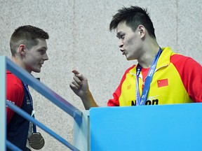 Sun Yang of China speaks with Duncan Scott of Great Britain during the medal ceremony for the Men's 200m Freestyle Final at the 2019 FINA World Championships on July 23, 2019 in Gwangju, South Korea.