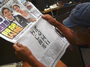 A journalist reads an ad in the Apple Daily newspaper in Taipei, Taiwan, on June 28, 2019, placed by a Hong Kong campaign group calling for solidarity with Hong Kong protesters.