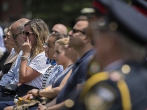 Claudine Debeaumont, the mother of Reese Fallon, who was killed during the Danforth shooting one year ago, wipes a tear from her face during an emotional commemoration of the Danforth shooting at Withrow Park in Toronto on Sunday, July 21, 2019.