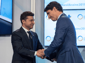 Prime Minister Justin Trudeau and Ukrainian President Volodymyr Zelenskiy embrace after Trudeau's address to the Ukrainian Reform conference in Toronto on July 2, 2019.