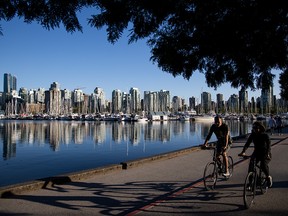 Cyclists ride along Coal Harbour marina in Vancouver on June 3, 2019.