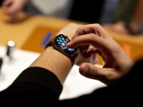 A customer uses an Apple Inc. Watch Series 4 smartwatch during a sales launch at a store in Chicago, Illinois, U.S., on Friday, Sept. 21, 2018.