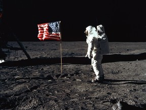 Astronaut Buzz Aldrin, lunar module pilot for Apollo 11, poses for a photograph besides the United States flag during an extravehicular activity on the moon, July 20, 1969.