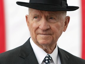 H. Ross Perot, an honorary member of the Special Forces regiment, stands in front of a statue (not shown) he commissioned and donated to the U.S. Army John F. Kennedy Special Warfare Center and School in Fort Bragg, North Carolina, U.S., Apr 5, 2012.