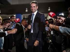 Greece's newly elected Prime Minister and leader of conservative New Democracy party Kyriakos Mitsotakis, speaks to the press outside the party's headquarters after the official results of the elections, in Athens on July 7, 2019.