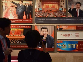 Journalists film a display featuring Chinese President Xi Jinping in the history museum  at the Party School of the Chinese Communist Party's Central Committee, during a government-organized tour for foreign journalists in Beijing on June 26, 2019.