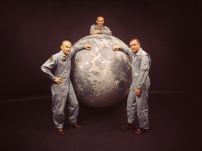 Portrait of American astronauts, from left, Buzz Aldrin, Michael Collins, and Neil Armstrong, the crew of NASA's Apollo 11 mission to the moon, as they pose on a model of the moon, 1969.