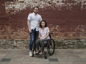 Survivors of the Danforth shooting attack Jerry Pinksen, left, and his partner Danielle Kane pose for a photograph at Liberty Village Park in Toronto on Friday, July 12, 2019.