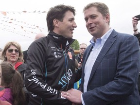 Prime Minister Justin Trudeau, shakes hands with Conservative Leader Andrew Scheer Thursday, June 14, 2018 in Saguenay Que.