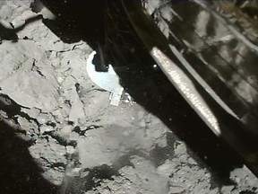 This handout photograph released by the Institute of Space and Astronautical Science (ISAS) of Japan Aerospace Exploration Agency (JAXA) on July 11, 2019 shows Hayabusa2 probe landing onto the asteroid Ryugu.