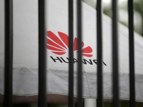 A Huawei logo is seen outside the fence at its headquarters in Shenzhen, Guangdong province, China May 29, 2019.