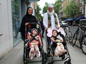 Two-year-old twins, born joined at the head, leave the hospital after a successful surgery at a British hospital in London, Britain July 1, 2019, in this handout photo released on July 16, 2019.