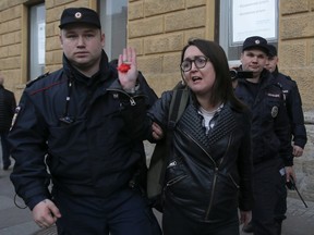 Police officers detain LGBT activist Yelena Grigoryeva during a rally held by activists of a local LGBT community, who protest against discrimination in Saint Petersburg.