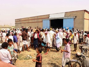 Displaced Yemenis from areas near the border with Saudi Arabia wait to receive World Food Programme (WFP) food aid, which according to local officials was stored and now is being distributed, in the northern district of Abs in the country's Hajjah province, on July 8, 2019.