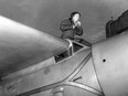 In this Jan. 13, 1935, file photo, Amelia Earhart climbs from the cockpit of her plane at Los Angeles, Calif., after a flight from Oakland to visit her mother.