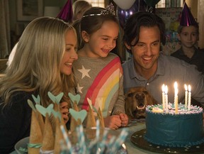 Milo Ventimiglia, Amanda Seyfried, and Ryan Kiera Armstrong in The Art of Racing in the Rain (2019).