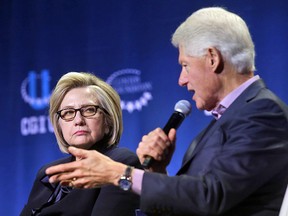 Former secretary of state Hillary Clinton listens as former president Bill Clinton speaks during the annual Clinton Global Initiative conference on October 16, 2018 in Chicago, Illinois.