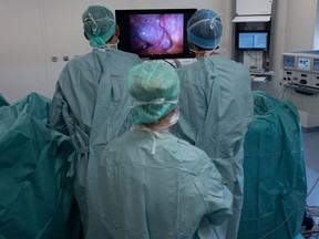 Surgeons look at a monitor on June 7, 2019, at the Georges-Francois Leclerc centre in Dijon, central-eastern France.