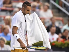 Nick Kyrgios of Australia holds his towel in his mouth against Kyle Edmund of Great Britain during day 5 of the Rogers Cup at IGA Stadium on August 6, 2019 in Montreal, Quebec, Canada.