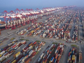Gantry cranes and containers stand at the Yangshan Deepwater Port, operated by Shanghai International Port Group Co., in this aerial photograph taken in Shanghai, China, on Aug. 7, 2019.