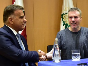 Kristian Lee Baxter (R), a Canadian formerly held captive by the Syrian government, shakes hands with the Lebanese Head of General Security Major-General Abbas Ibrahim (L), during a press conference following Baxter's release after an eight-month captivity, in the Lebanese capital Beirut on August 9, 2019.