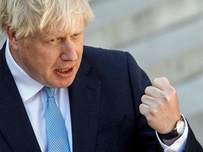 British Prime Minister Boris Johnson speaks to the press on Aug. 22, 2019, before a meeting at The Elysee Palace in Paris with French President Emmanuel Macron.