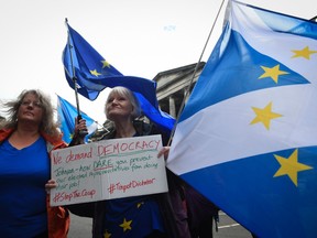 A protestor demonstrates against Conservative Prime Minister Boris Johnson's decision to suspend parliament outside the Court Of Session in Edinburgh, Scotland on August 30, 2019.