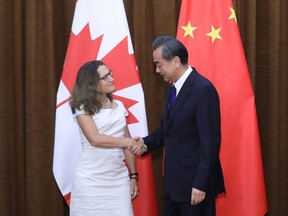 Canada's Foreign Minister Chrystia Freeland shakes hands with her Chinese counterpart Wang Yi as she arrives for a meeting at the Ministry of Foreign Affairs in Beijing on August 9, 2017.
