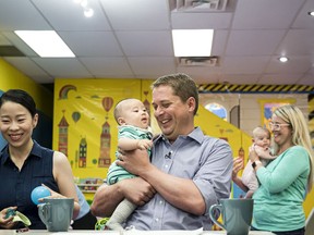 Federal Conservative leader Andrew Sheer holds 4-month old Antonio Wang while caregiver Anna Yang watches at a child care facility where he gave an announcement, in Toronto, on Tuesday, August 20, 2019. Conservative Leader Andrew Scheer is promising to provide a tax credit for new parents receiving federal benefits.Scheer is reviving an idea he first unveiled in early 2018 as a carrot for families in this fall's election.