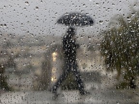 Heavy rain is being reported in parts of the Maritimes as Erin, now a post-tropical weather system, advances toward the region. Raindrops appear on a window as a man crosses a street in San Francisco, Wednesday, Jan. 4, 2017.