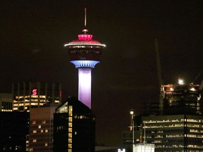 The Calgary Tower is lit up with the colors of the French flag to show support and sympathy regarding the Paris attacks in Calgary, Alta. on Friday, Nov. 13, 2015. One of Calgary's most recognizable landmarks remains closed seven weeks after an elevator with eight people on board plunged several floors.
