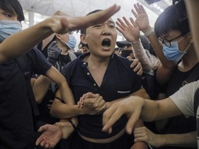 Protesters detain a man, who protesters claimed was a Chinese undercover agent during a demonstration at the Airport in Hong Kong, Tuesday, Aug. 13, 2019.The federal government is warning Canadians about travelling to Hong Kong amid massive protests and the Chinese military amassing on the border.The travel advisory went up around 9:30 ET this morning telling Canadians to "exercise a high degree of caution in Hong Kong due to ongoing large-scale demonstrations."