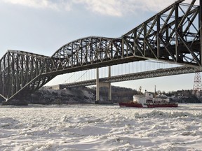 The federal government says its ready to pass a law forcing Canadian National Railway to restore the historic Quebec Bridge. Canadian Coast Guard ice breaker Pierre-Radisson clears the ice flow under the Quebec bridge on the St-Lawrence River in front of Quebec City, Wednesday, January 8, 2014.