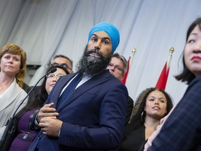 NDP Leader Jagmeet Singh, surrounded by party members, speaks to the media following a speech at the Ontario NDP Convention in Hamilton, Ont., Sunday, June 16, 2019. A spokeswoman for Singh says an event designed to be a constituency open house was mistakenly identified as a campaign event in an email.THE CANADIAN PRESS/Tara Walton