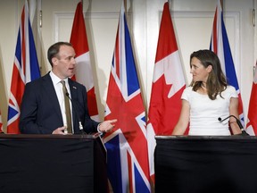 Canada's Minister of Foreign Affairs Chrystia Freeland glances at British Foreign Secretary Dominic Raab as he speaks during a press conference following a bilateral meeting in Toronto, Tuesday, Aug. 6, 2019. Freeland and her British counterpart say they're both concerned about two Canadians detained in China.