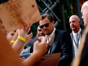 U.S. actor Leonardo DiCaprio signs autographs as he arrives for the German premiere of director Quentin Tarantino's latest film, Once Upon A Time In Hollywood, in Berlin on Aug. 1, 2019.