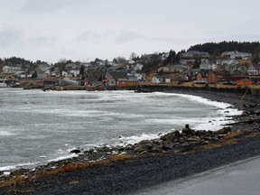 A view across the ice covered bay towards the town of Dildo, early spring scene at the Trinity Bay along the Baccalieu trail, Newfoundland Canada.