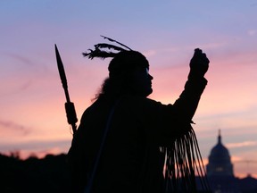 Maurice Cato, a Cherokee from West Virginia, prays to Mother Earth and Grandfather Sky before the opening of the Smithsonian's National Museum of the American Indian on Sept. 21, 2004.