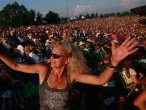 Jane Bulger, who attended the original concert, dances during the concert marking the 40th anniversary of the Woodstock music festival August 15, 2009 in Bethel, New York.