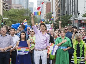 Prime Minister Justin Trudeau, centre, pauses for a moment of silence during the annual pride parade with from left, Quebec Premier Francois Legault, Montreal Mayor Valerie Plante, Liberal MP Melanie Joly and Green Party leader Elizabeth May in Montreal, Que. Sunday, August 18, 2019.