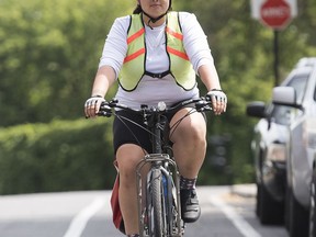 Hannah Tooktoo cycles along a street in Montreal, Thursday, August 8, 2019. Hannah has been biking across Canada to raise awareness about suicides in the north.