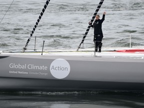 Swedish teenage climate activist Greta Thunberg waves from a yacht as she starts her trans-Atlantic boat trip to New York, in Plymouth, Britain, August 14, 2019.