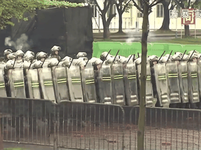This screengrab taken from an undated video from China's People's Liberation Army Hong Kong Garrison shows soldiers marching and firing during an "anti-riot" drill in Hong Kong.