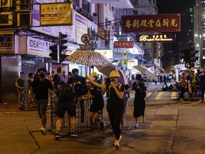 Demonstrators push a barricade along Kings Road during a protest in the North Point district of Hong Kong, China, on Monday, Aug. 5, 2019.