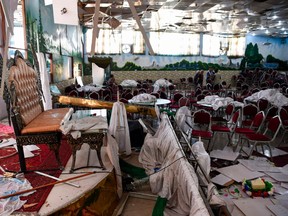 Afghan men investigate in a wedding hall after a deadly bomb blast in Kabul on Aug. 18, 2019. More than 60 people were killed and scores wounded in an explosion targeting a wedding in the Afghan capital, authorities said on Aug. 18, the deadliest attack in Kabul in recent months.