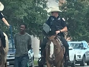 Mounted officers are seen leading away Brandon Neely, arrested on suspicion of criminal trespassing, in the island city Galveston, Texas.