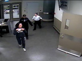 Huawei CFO Meng Wanzhou is escorted by Canada Border Services Agency (CBSA) staff during her arrival at Vancouver International airport in which she was arrested on a U.S. warrant, in a still image from video taken in Richmond, British Columbia, Canada December 1, 2018 and released August 21, 2019.